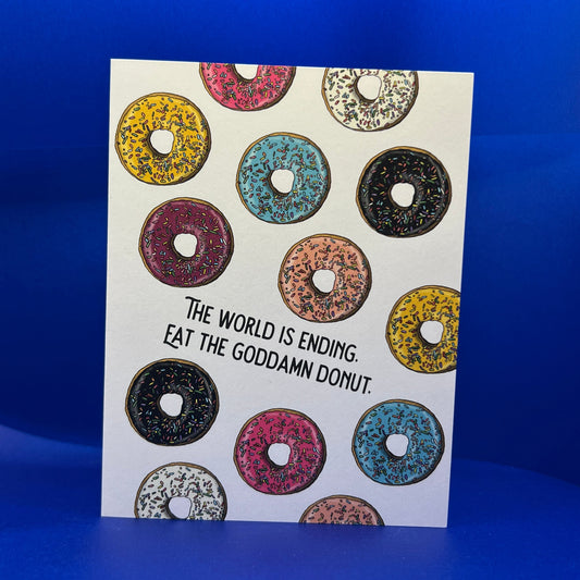 Sticker with colorful donut design and text on a blue background