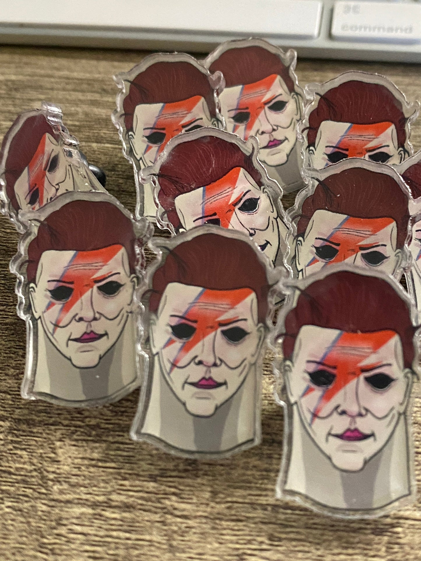 Multiple identical figurines of a character with a brown head and white face on a wooden surface.