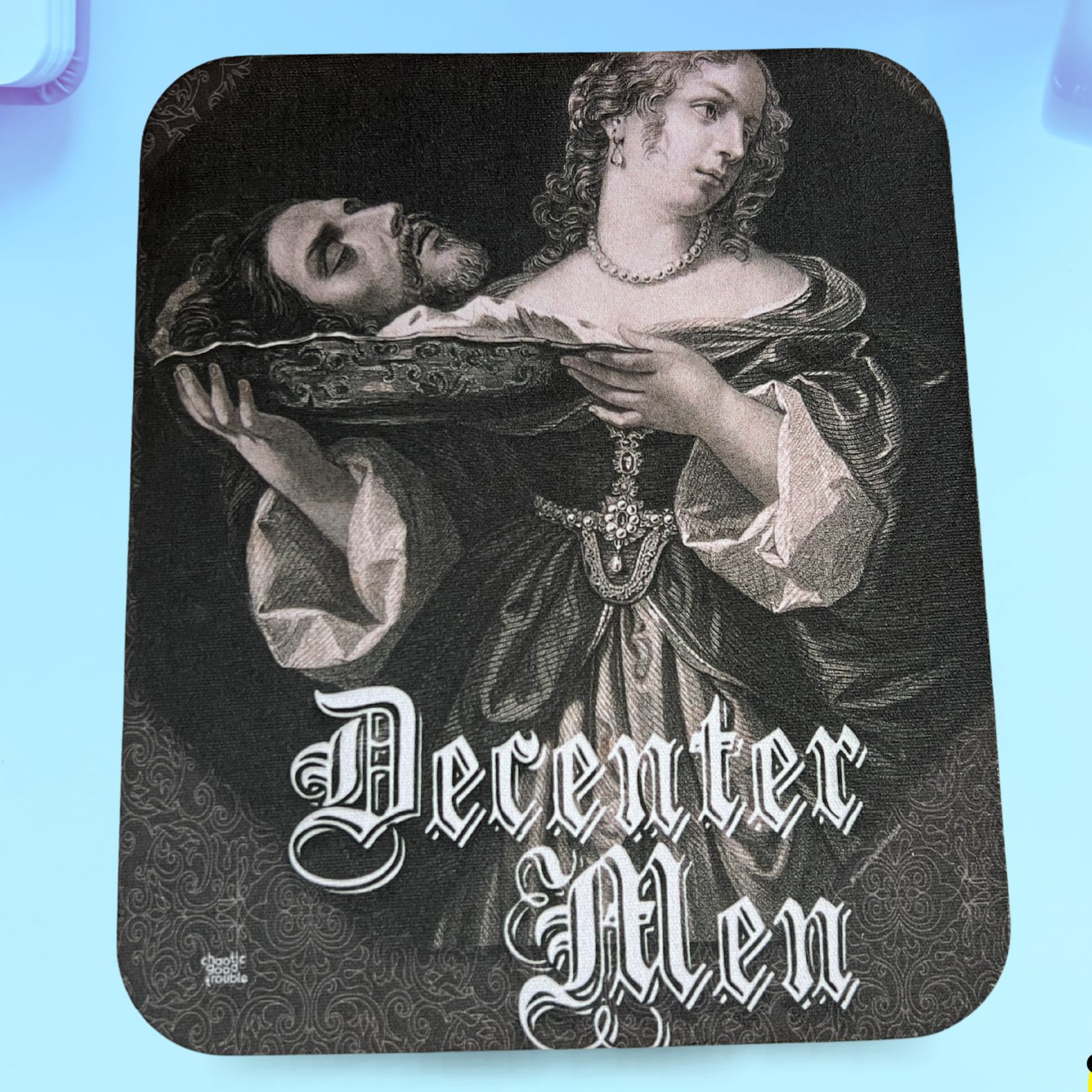 Mousepad with vintage-style illustration of a man and woman holding a tray, with 'Decenter Men' text on a blue gradient background.