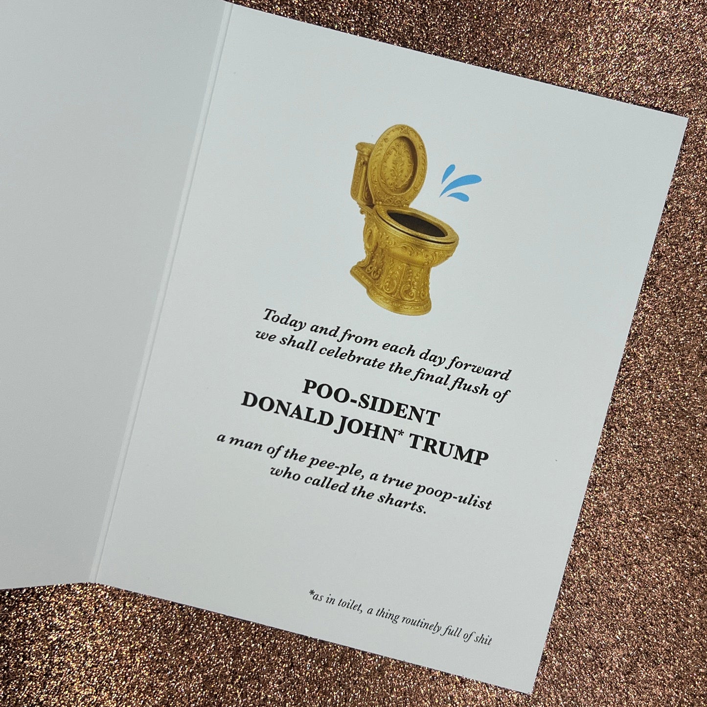 Card with a cartoon illustration of a gold toilet and text on a brown textured background